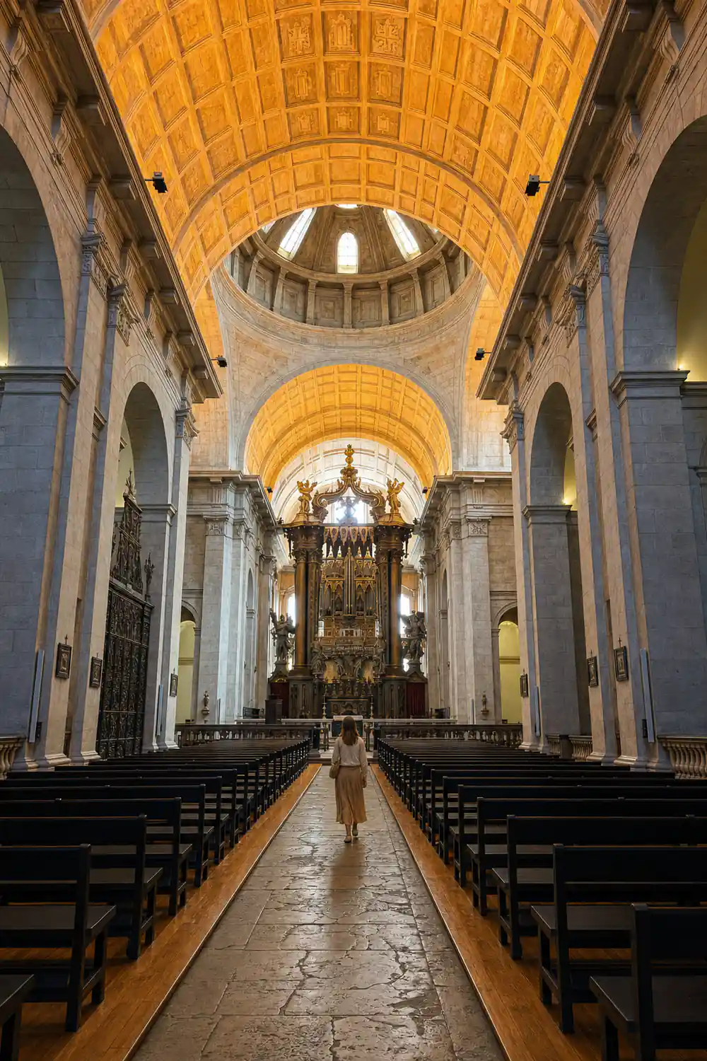 A barrel vaulted church interior above rows of empty benches