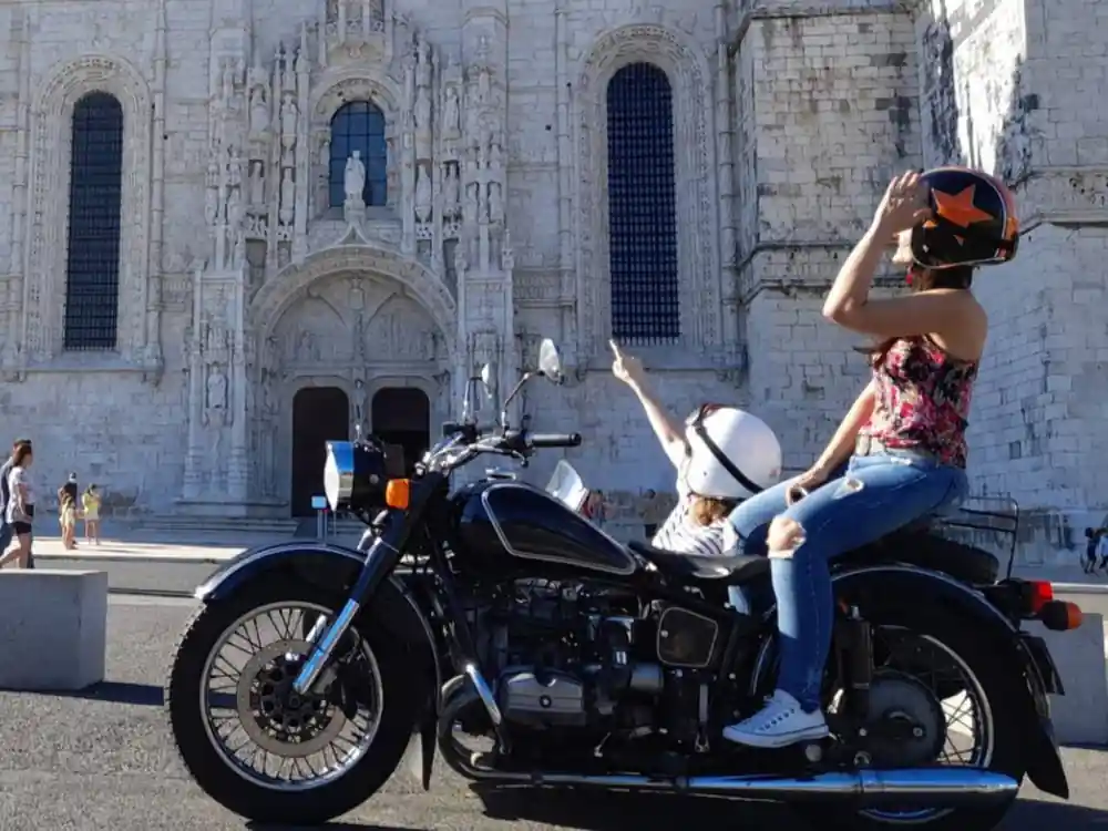A black sidecar parked before the carved facade of the Jeronimos Monastery