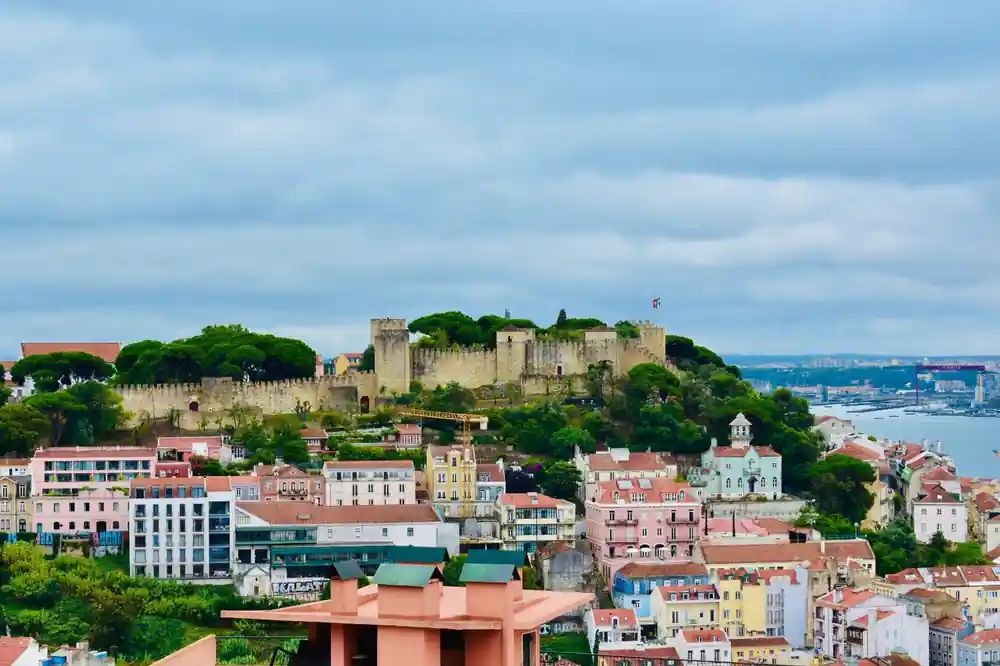 The castle on its hill seen across a slope of terracotta rooftops
