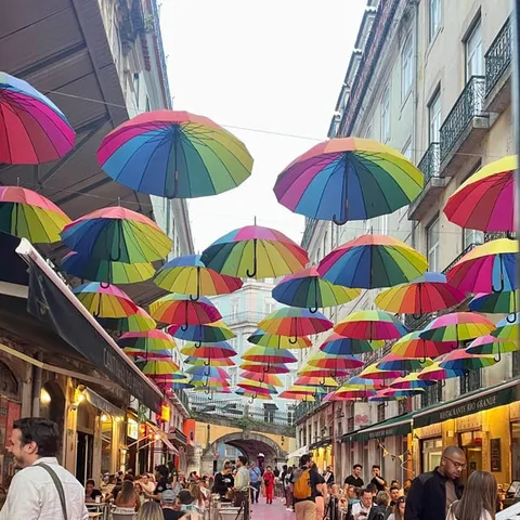 Colourful umbrellas hanging over Pink Street in Lisbon